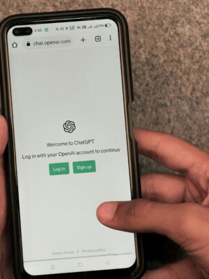 Webpage of ChatGPT, a prototype AI chatbot, is seen on the website of OpenAI, on a smartphone. Examples, capabilities, and limitations are shown.